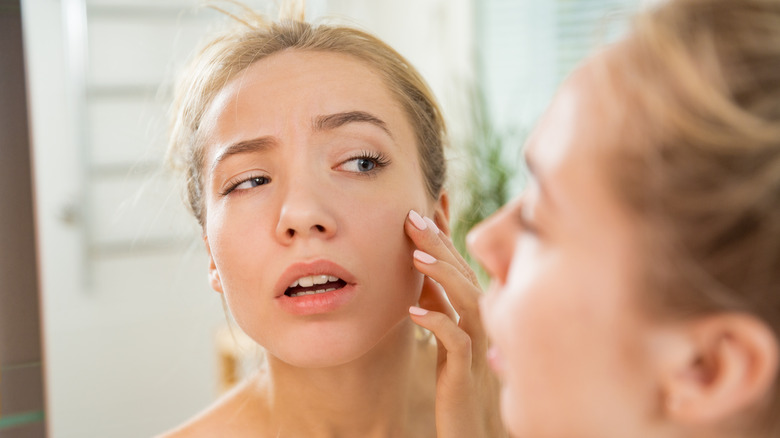 Woman stares in mirror