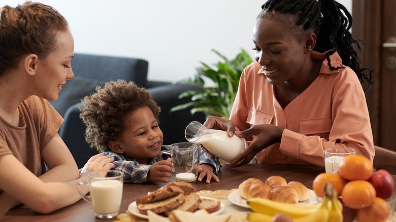 Couple and child eating at table