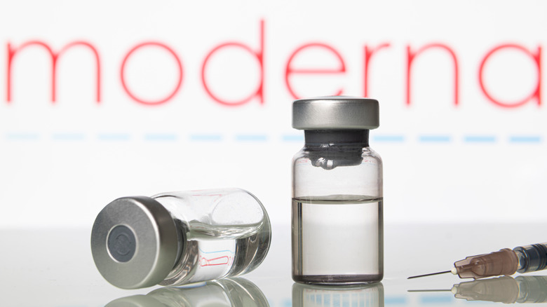 Two vials of Moderna vaccine and syringe