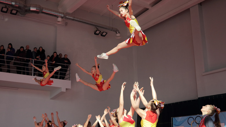 group of cheerleaders flying in the air