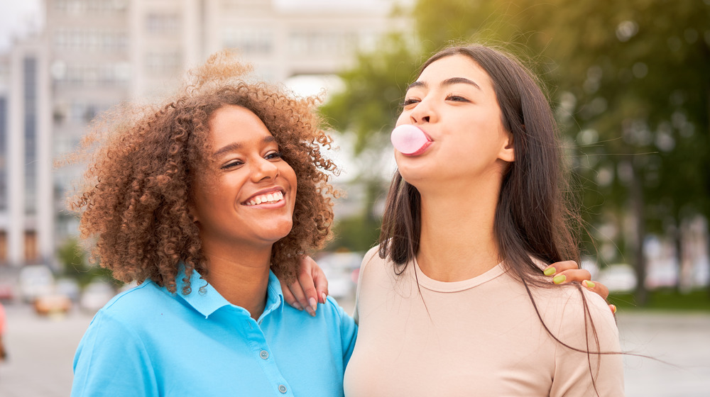 Friends blowing bubbles with gum