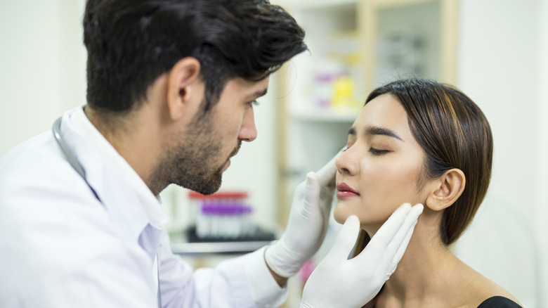 dermatologist treating skin tags on eyelid