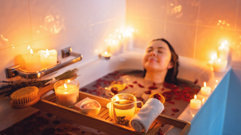 Woman relaxing in candlelit bath