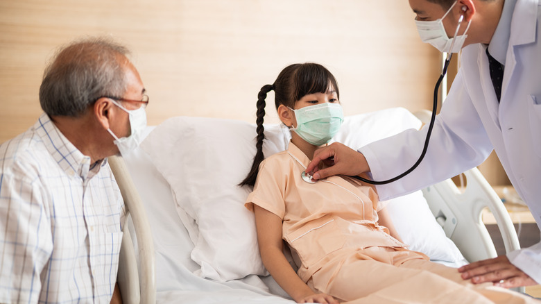 girl getting checked by doctor 