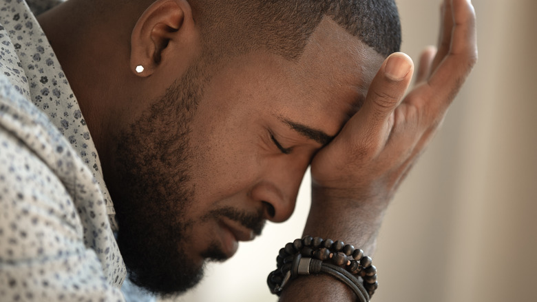 Man resting head in palm