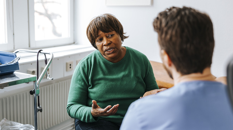 woman talking to her doctor in his office