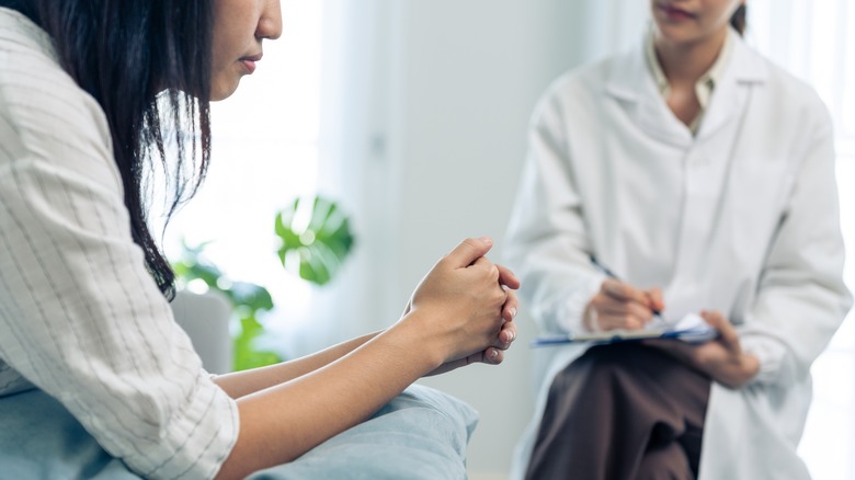 Doctor and patient sit in office