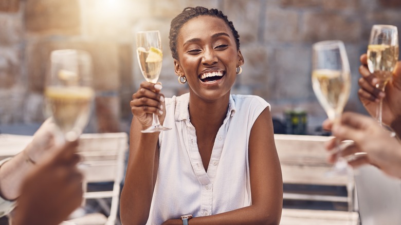 woman enjoying a glass of wine with friends