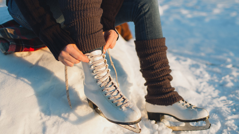 Legs wearing ice skates and leg warmers