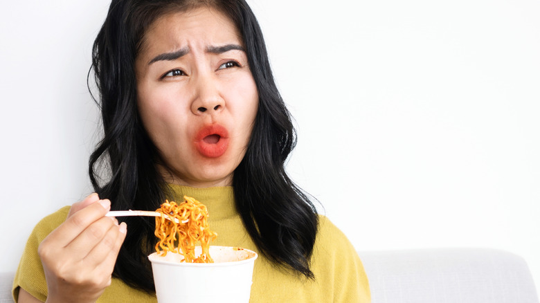 woman trying to cool off from eating spicy food