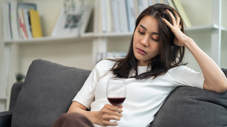 sleepy woman drinking red wine