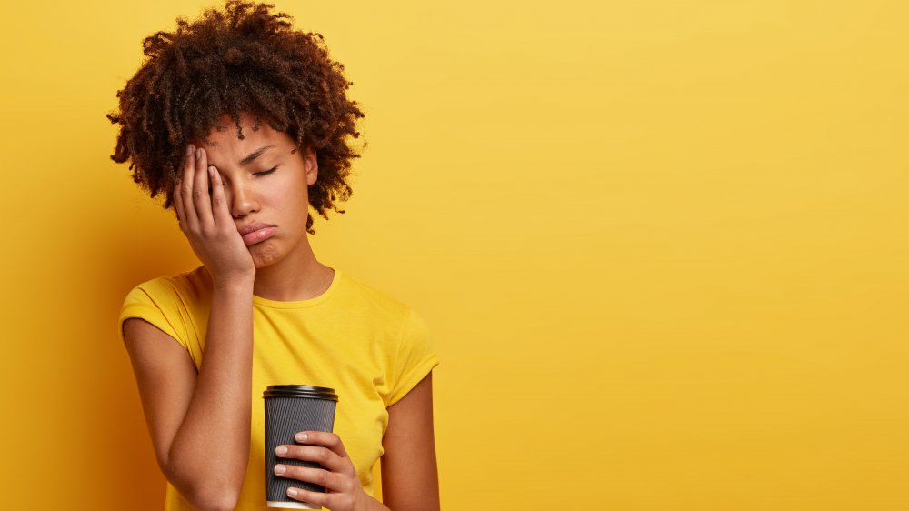 Tired woman with coffee cup