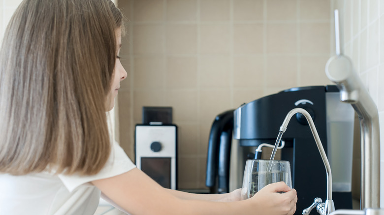 Girl using water filter