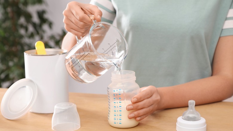 Woman making baby formula
