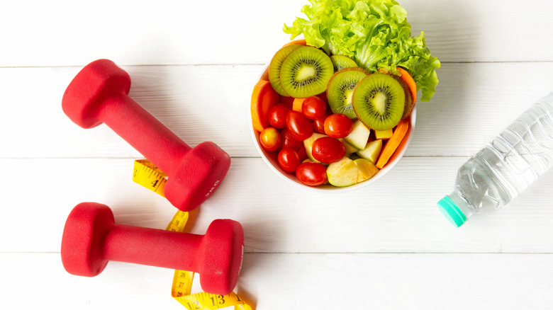 bowl of fruit with dumbbells