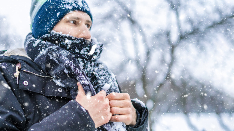 Man in coat walking in snow