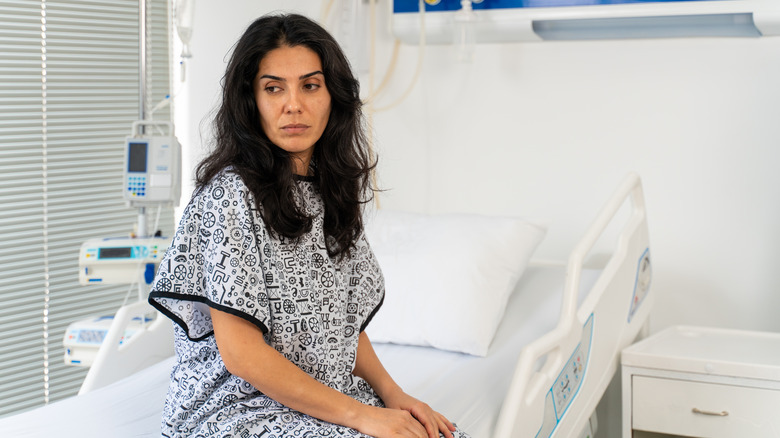 Woman sitting on hospital bed