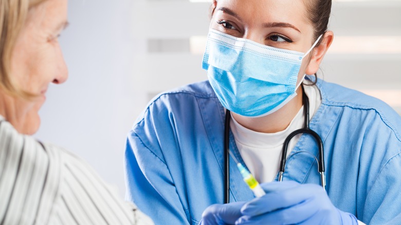 A nurse gives a vaccine