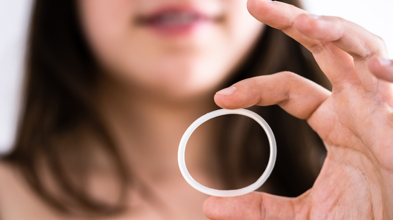 woman holding contraceptive ring