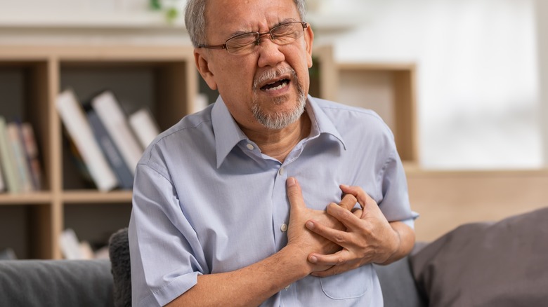 Elderly man experiencing heart attack