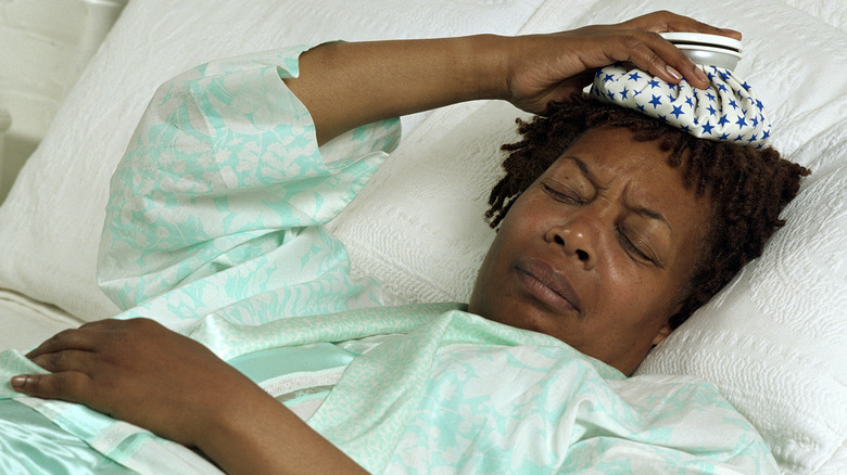 Woman in bed with painful migraine