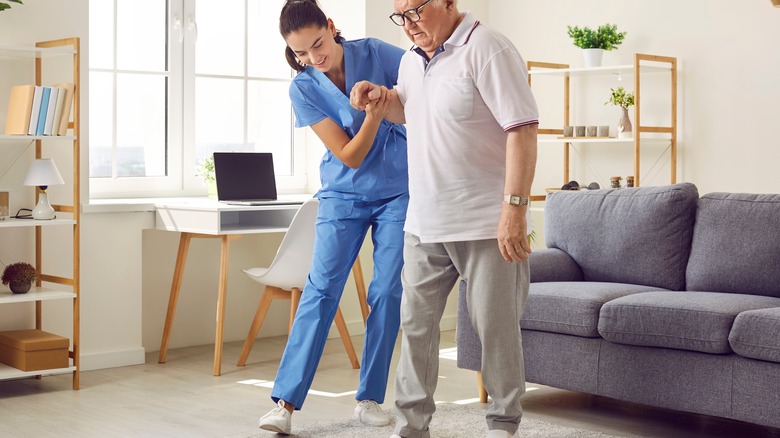 Nurse helping person to walk