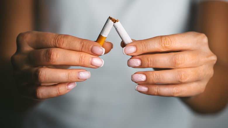 Person breaking a cigarette