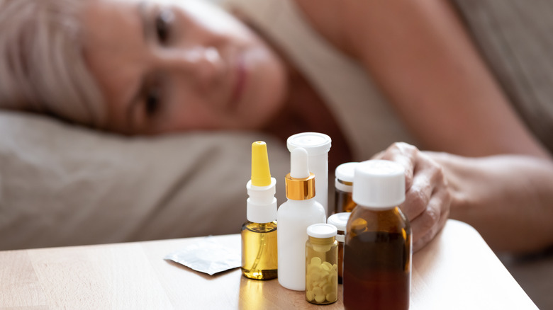Woman with medications on nightstand