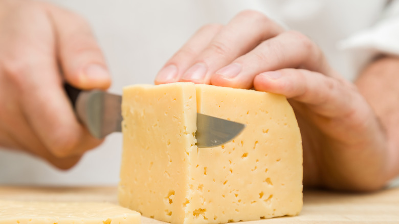 smiling woman tasting cheese