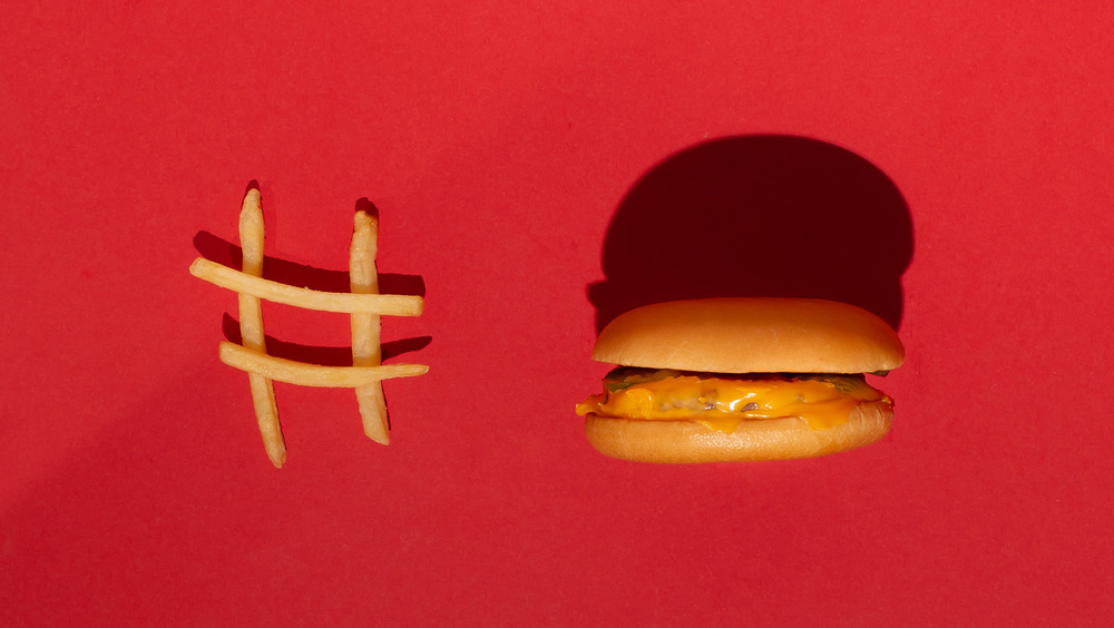 French fries in the shape of a pound sign next to a cheeseburger