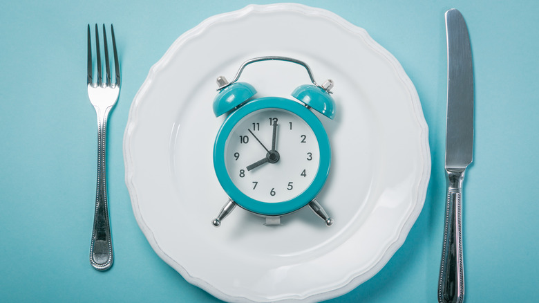 clock on plate with utensils