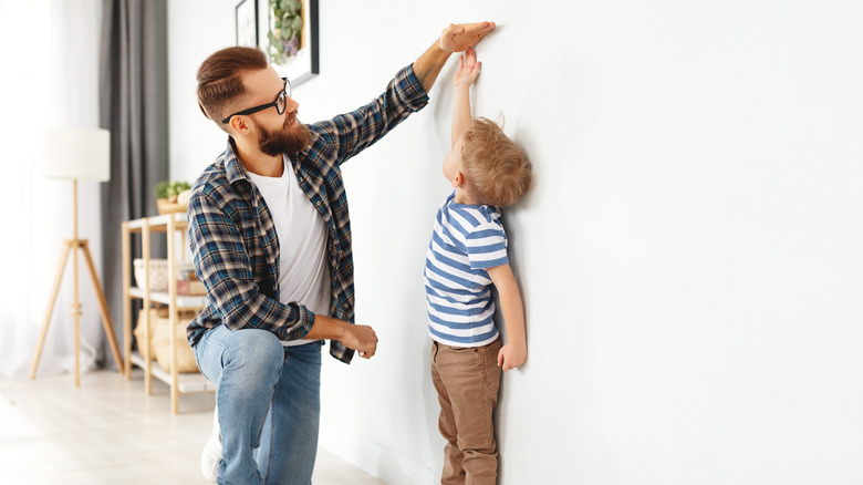 Father measuring son