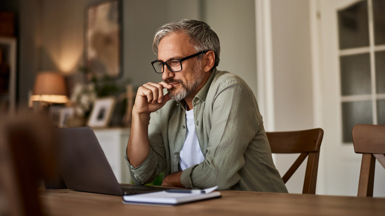 middle-aged man working on laptop