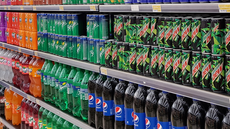 A variety of sodas on a grocery store shelf