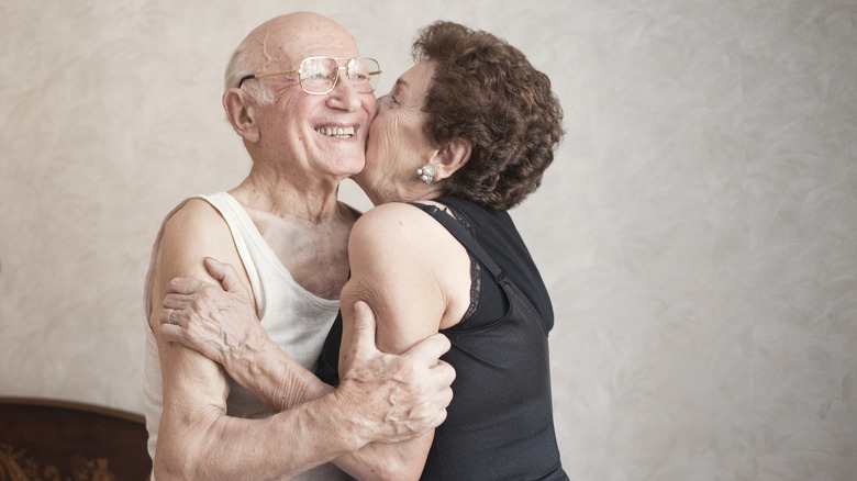 elderly couple kissing