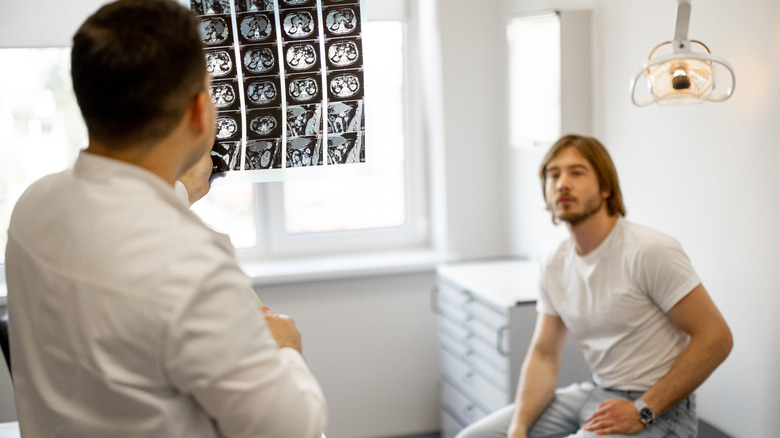 Doctor showing patient abdominal imaging