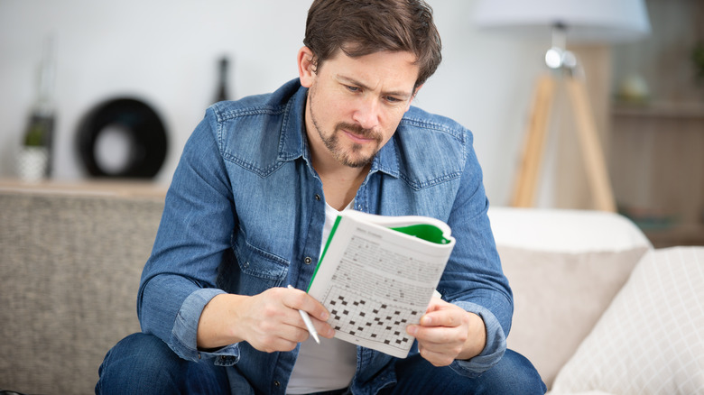 A man does a crossword puzzle