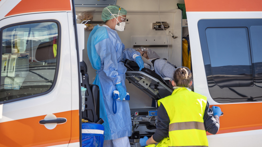 Stock photo of paramedics with a COVID patient