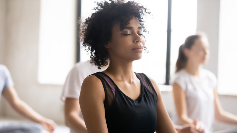 woman focusing on her breathing in yoga class 