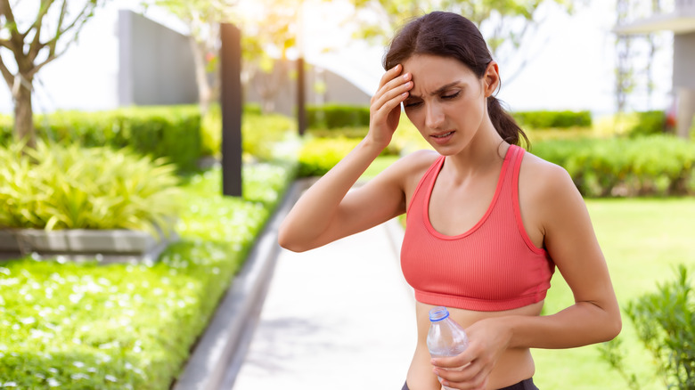 Fit woman feeling fatigued, a side effect of sodium restriction