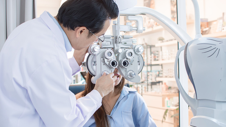 A doctor performs an eye exam