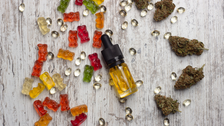 flat lay of weed gummies, extract, flower, and capsules