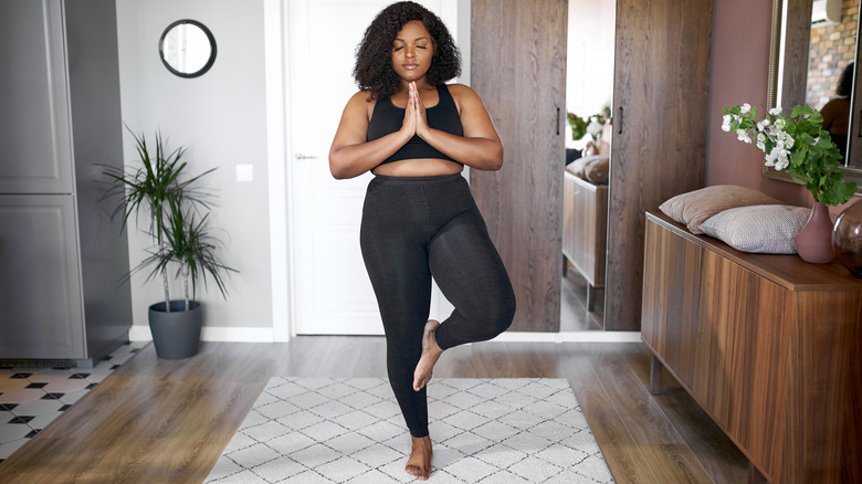 woman doing yoga at home