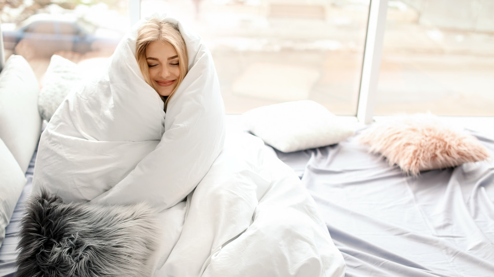 woman wrapped in comforter