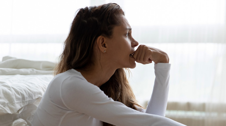 anxious woman biting fingers