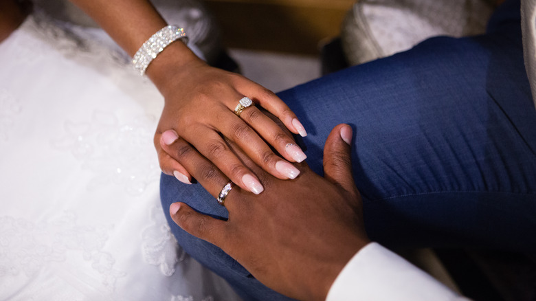 closeup of wedding bands on newlyweds hands
