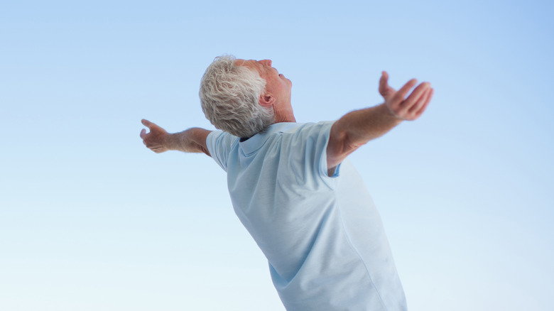 man doing a standing stretch