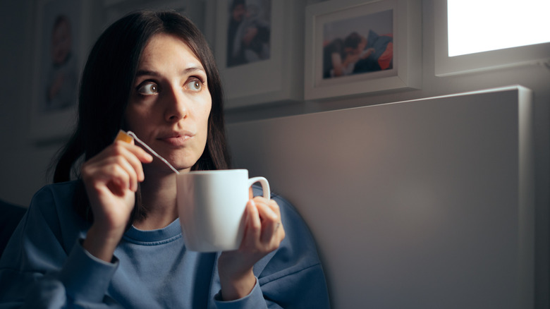 A woman drinking tea before bed