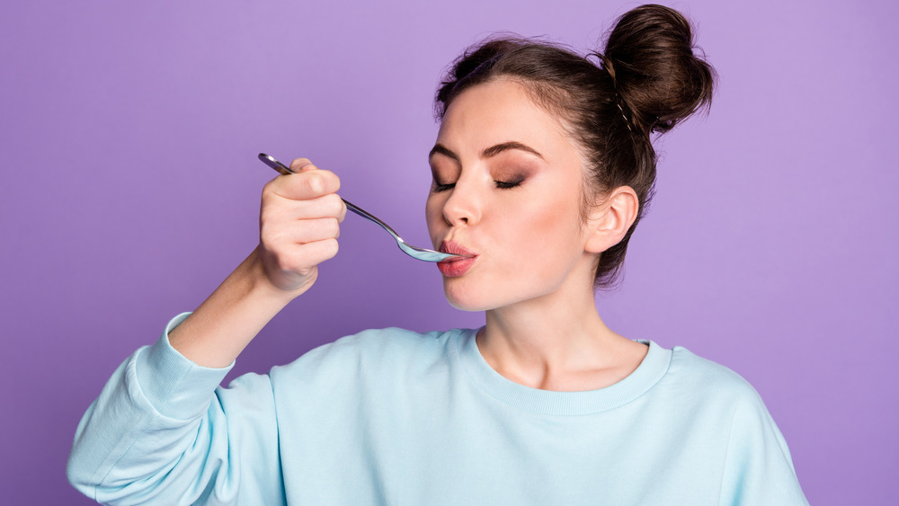 woman eating from spoon