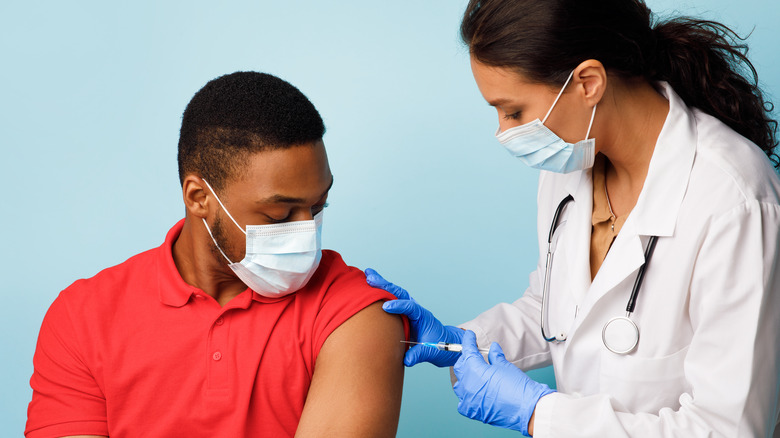 doctor giving a COVID-19 vaccine 